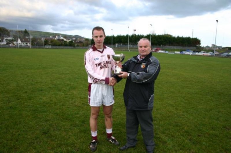 Antrim Vice-Chairman Joe Edwards presents the 2012 Senior Reserve League Cup to Captain Eoin Gillan